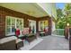 Cozy outdoor patio with brick accents, comfortable seating, and ceiling fan at 221 Grayrock Dr, Statesville, NC 28677