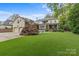 Large backyard featuring a well-maintained lawn, patio area, and beautiful landscaping, perfect for outdoor enjoyment at 2322 Hopedale Ave, Charlotte, NC 28207
