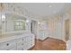 Spacious bathroom featuring dual sinks, large mirrors, and floral wallpaper at 2322 Hopedale Ave, Charlotte, NC 28207
