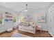 Bright bedroom featuring a comfortable daybed, large windows for lots of natural light, and hardwood floors at 2322 Hopedale Ave, Charlotte, NC 28207