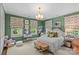 Charming bedroom with green walls, floral curtains, white carpet, and comfortable furniture at 2322 Hopedale Ave, Charlotte, NC 28207