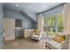 Bright bedroom retreat featuring a large window with views and cozy armchairs at 2322 Hopedale Ave, Charlotte, NC 28207