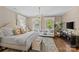 Comfortable bedroom with light walls, light furnishings, and light hardwood floors at 2322 Hopedale Ave, Charlotte, NC 28207