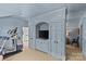 Open space with an exercise machine and a bedroom visible through an archway, all tied together with light blue tones at 2322 Hopedale Ave, Charlotte, NC 28207