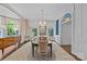 Formal dining room features a decorative chandelier, large windows, custom wall art and plush chairs at 2322 Hopedale Ave, Charlotte, NC 28207