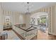 Upstairs landing with chandelier and view into a study with built in bookcases at 2322 Hopedale Ave, Charlotte, NC 28207