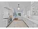 Bright gourmet kitchen with white cabinets, marble countertops, and stainless steel appliances at 2322 Hopedale Ave, Charlotte, NC 28207