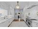 Bright gourmet kitchen with white cabinets, marble countertops, and stainless steel appliances at 2322 Hopedale Ave, Charlotte, NC 28207
