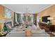 Spacious living room features large windows, custom draperies, ample seating, and a cozy fireplace at 2322 Hopedale Ave, Charlotte, NC 28207