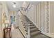 Inviting staircase with patterned carpet and neutral wallpaper, showcasing a glimpse into the living space at 2322 Hopedale Ave, Charlotte, NC 28207