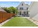 Gorgeous backyard with lush artificial turf, patio seating, and privacy fence at 2509 Bay St, Charlotte, NC 28205