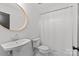 Classic bathroom featuring white sink, toilet, and shower with chrome fixtures and white tile at 2509 Bay St, Charlotte, NC 28205