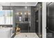 Modern bathroom with a glass shower featuring dark herringbone tiling and elegant fixtures at 2509 Bay St, Charlotte, NC 28205