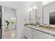 Bright bathroom featuring double vanity, stylish mirrors, modern fixtures, and unique patterned tile flooring at 2509 Bay St, Charlotte, NC 28205