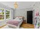 Cozy bedroom with floral wallpaper, chandelier, plush rug, and a black door at 2509 Bay St, Charlotte, NC 28205