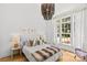 Bright bedroom featuring hardwood floors, a statement chandelier, and comfortable furnishings at 2509 Bay St, Charlotte, NC 28205