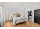 Bright and airy bedroom featuring hardwood floors, a ceiling fan, and a glimpse of the ensuite bathroom at 2509 Bay St, Charlotte, NC 28205