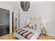 Bright bedroom featuring hardwood floors, a statement chandelier, and comfortable furnishings at 2509 Bay St, Charlotte, NC 28205