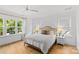 Bright and airy bedroom featuring a ceiling fan, hardwood floors and large windows at 2509 Bay St, Charlotte, NC 28205