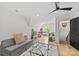 Bright bonus room with hardwood floors, a gray sofa, and an area for toys at 2509 Bay St, Charlotte, NC 28205