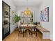 Charming breakfast nook with built-in bench seating, a round table, designer lighting and large picture windows at 2509 Bay St, Charlotte, NC 28205