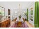 Formal dining room featuring hardwood floors, a stylish chandelier, and large windows at 2509 Bay St, Charlotte, NC 28205