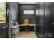 Stylish home office with built-in desk, dark walls, herringbone floors, and ample natural light at 2509 Bay St, Charlotte, NC 28205
