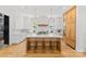 Spacious kitchen featuring a large island, custom cabinetry, quartz countertops and modern, geometric pendant lighting at 2509 Bay St, Charlotte, NC 28205