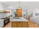 Open kitchen concept with a large island, wooden cabinets, stainless appliances and seamlessly flowing into the living area at 2509 Bay St, Charlotte, NC 28205