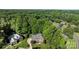 Aerial shot of beautiful brick home in neighborhood surrounded by mature trees at 2608 Carmarthen Ct, Matthews, NC 28104