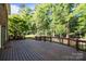 A large deck with railings provides ample space for outdoor living and entertaining at 2608 Carmarthen Ct, Matthews, NC 28104