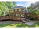 A beautiful brick home has a large deck and a well-maintained backyard at 2608 Carmarthen Ct, Matthews, NC 28104