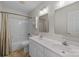 Bright bathroom features double sinks, a tub-shower, and ample storage at 2608 Carmarthen Ct, Matthews, NC 28104