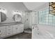 This bathroom features a soaking tub, walk-in shower, and a double vanity with granite countertop at 2608 Carmarthen Ct, Matthews, NC 28104