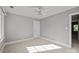 Bedroom features a ceiling fan, neutral paint, and carpet, and a door to another room at 2608 Carmarthen Ct, Matthews, NC 28104