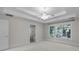 The bedroom features a trey ceiling with ceiling fan, large window with wooded view, and en suite bathroom at 2608 Carmarthen Ct, Matthews, NC 28104
