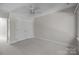 Bright bedroom features neutral carpet, a ceiling fan, and a large closet at 2608 Carmarthen Ct, Matthews, NC 28104