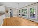 Sunny dining area with hardwood floors, large windows, and a view to the laundry at 2608 Carmarthen Ct, Matthews, NC 28104
