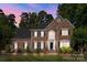 Charming two-story brick home with a manicured lawn, elegant black shutters, and a grand entrance at 2608 Carmarthen Ct, Matthews, NC 28104