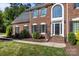 Charming brick home showcasing a large front window, black shutters, and well-maintained landscaping at 2608 Carmarthen Ct, Matthews, NC 28104