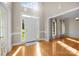 Bright foyer with hardwood floors, a grand front door, and views of a well-lit dining room at 2608 Carmarthen Ct, Matthews, NC 28104