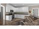 Bright kitchen with granite counters, stainless steel appliances, and white cabinets provides ample counter space at 2608 Carmarthen Ct, Matthews, NC 28104