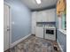 This laundry room features a washer, dryer, utility sink, storage cabinets, and a window for natural light at 2608 Carmarthen Ct, Matthews, NC 28104
