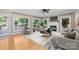 A bright living room features hardwood floors, an elegant fireplace, and a view of the backyard at 2608 Carmarthen Ct, Matthews, NC 28104