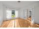 Sun-filled living room with hardwood floors, large windows, and elegant French doors at 2608 Carmarthen Ct, Matthews, NC 28104