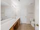 Well-lit bathroom featuring a double vanity and neutral tile flooring at 2704 Polo Club Blvd, Matthews, NC 28105