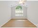 Spacious bedroom with vaulted ceilings, light wood floors, and an arched window at 2704 Polo Club Blvd, Matthews, NC 28105