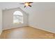 Light-filled bedroom with vaulted ceilings and large arched window at 2704 Polo Club Blvd, Matthews, NC 28105