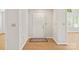 Bright foyer with hardwood floors, neutral paint, and a view to the rest of the home at 2704 Polo Club Blvd, Matthews, NC 28105