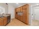 An open-concept kitchen boasts wood cabinets, stainless dishwasher, and granite countertops at 2704 Polo Club Blvd, Matthews, NC 28105